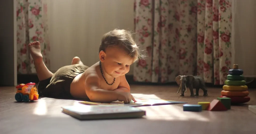 baby reading with toys, sybmolizing unisex names with biblical meaning